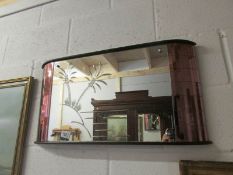 An art deco deep cut mirror with amber glass panels.