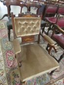 An Edwardian inlaid arm chair,