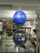 A Chinese blue oil lamp with blue shade.