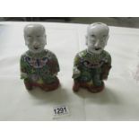 A pair of early 19th century Chinese pottery laughing boys (He-He boys) a/f.