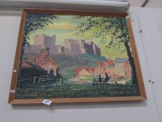 An oil on board painting of castle overlooking village 'Bamburgh', signed Donald Wall 1964.