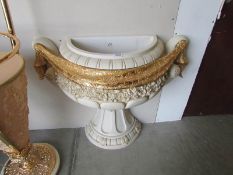 A large Romanesque urn wall planter.