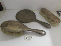 2 silver backed brushes and a silver backed hand mirror all a/f.
