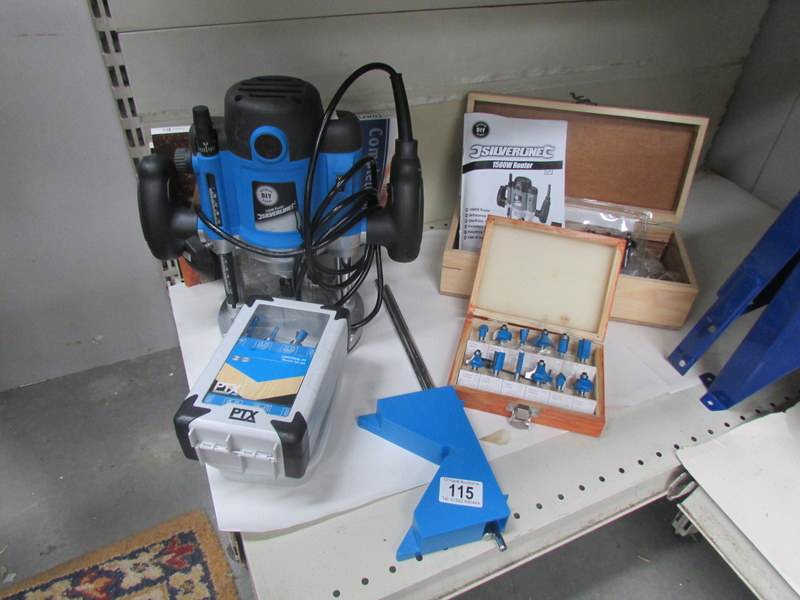 A Silverline 1800w router with 2 books router and cutting bits.