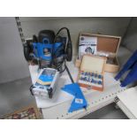 A Silverline 1800w router with 2 books router and cutting bits.