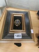 A framed Victorian mourning brooch,