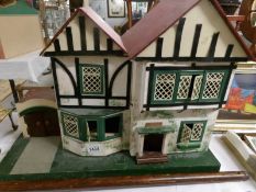 An old dolls house with furniture.