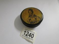 A 19th century lacquered pill box with portrait on top.