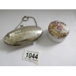 An engine turned silver purse dated 1915 and a painted lidded pot.