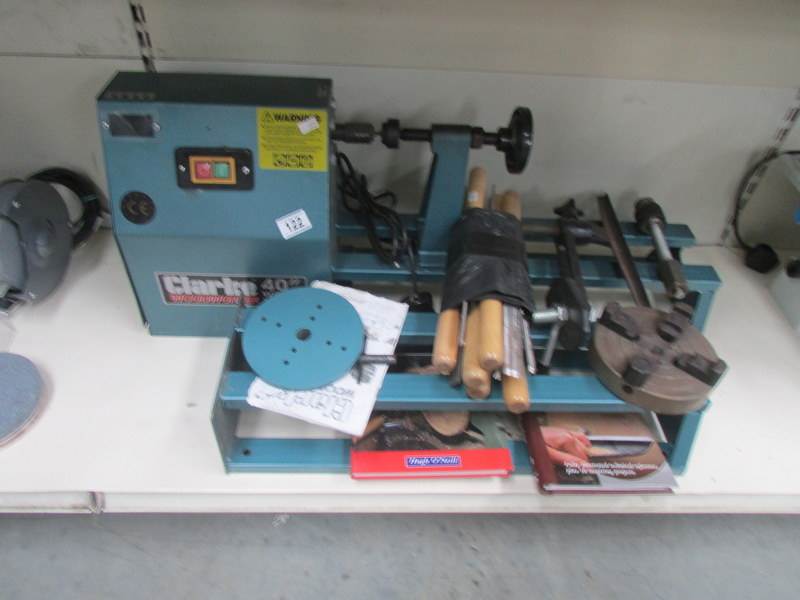 A Clarke woodworker 40" lathe with chisels and 2 books.