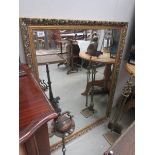 A large gilt framed bevel edged mirror.