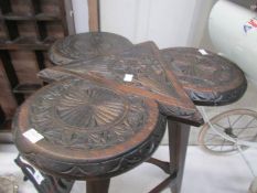 A carved side table.
