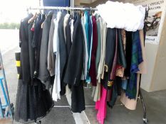 A rail of vintage clothing etc