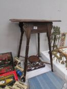 A carved top side table with under gallery.