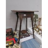 A carved top side table with under gallery.