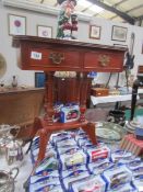 A mahogany effect side table with drawer.