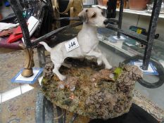 A figure of a Jack Russell dog on cork base