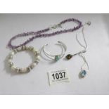 A turquoise bangle, an amethyst necklace, a gem pendant and a pearl bracelet.