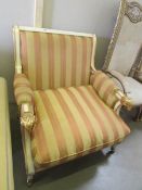 A French style arm chair with gilded rams head arms.