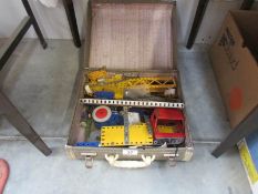 A case of old Meccano, plates, cogs etc.