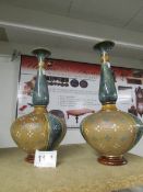 A pair of Royal Doulton vases with bulbous base,