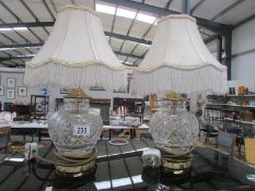 A pair of glass table lamps with shades.