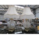 A pair of glass table lamps with shades.