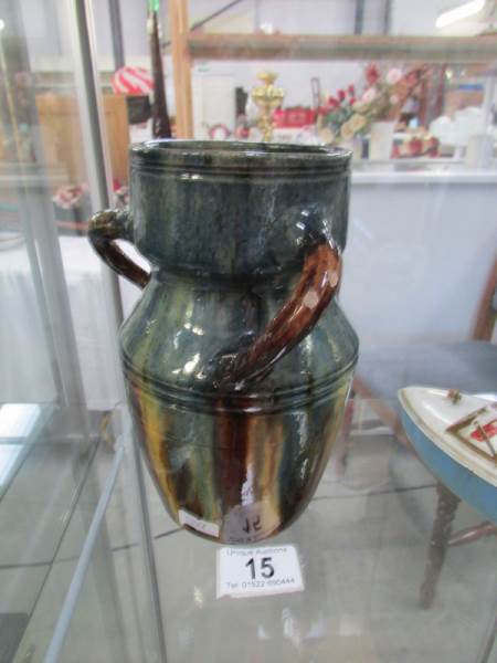 A late 19th / early 20th century 3 handled treacle glazed jug.