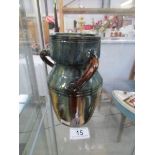 A late 19th / early 20th century 3 handled treacle glazed jug.