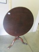 A mahogany tip top tripod table.