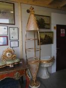 An unusual gilded and illuminated display stand (missing glass shelves).