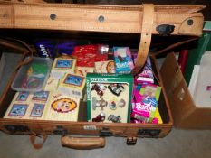 A suitcase of collectables including Barbie, Thunderbirds, Wallace & Gromit etc.