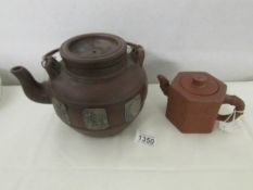 A large Yixing clay teapot and a 19th century signed Yixing teapot,.