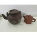 A large Yixing clay teapot and a 19th century signed Yixing teapot,.