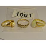 An 18ct gold ring set opal, an 18ct gold ring set pearl and an 18ct gold ring set clear stones,.