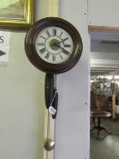 A Victorian postman's alarm clock with pendulum and 2 weights.