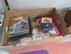 A good mixed lot including 2 postcard albums, postcards, dice, card games etc.