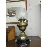 A Victorian oil lamp with etched shade,