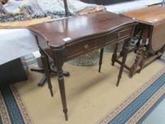 A mahogany fold over games table on reeded legs.