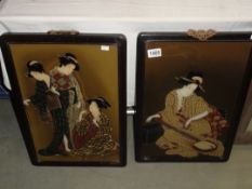 A pair of framed and glazed Japanese Geisha painted panels.