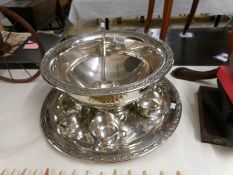 A silver plate punch bowl with 6 cups, ladle and tray.