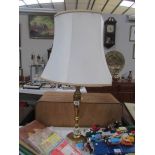 A brass table lamp with shade.