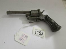 A 19th century pistol with engraved metal parts and carved stock.