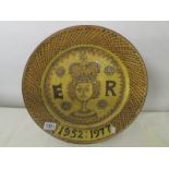 A large pottery charger commemorating the Silver Jubilee of Queen elizabeth II in a medieval style