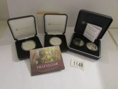 A 2005 Trafalgar silver proof coin, A Battle of Trafalgar £5 coin and a Gilbraltar Nelson coin.