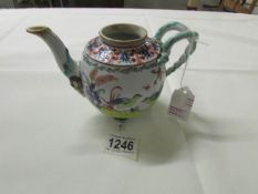 An 18th century teapot of European design with French and Chinese influences (lid missing).