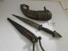 An old dagger and a horn shaped leather powder flask.