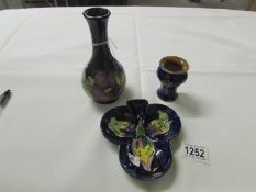 2 small Moorcroft vases and a Moorcroft dish.