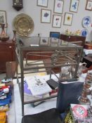 A metal and glass occasional table.