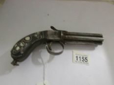 A 19th century pepperpot pistol with inlaid stock.